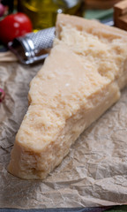 One piece of authentic Parmigiano-Reggiano or Parmesan Italian hard, granular cheese
