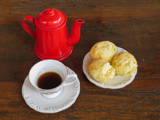 Yummy coffee in the cup and cheese bread. red teapot
