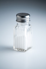 Vintage Salt Shaker with Salt on a White Background