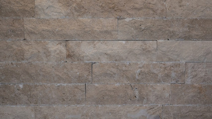 Beige brown rustic natural stone wall texture background