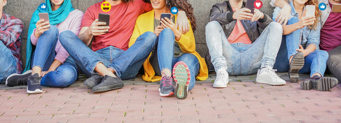 Young friends using smart mobile phones - Teenagers addiction to new technology trends - Concept of...