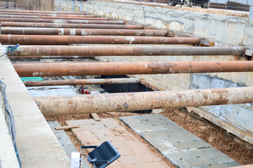 A large huge ditch pit tunnel with reinforcing structures from thick iron pipes of beams and...