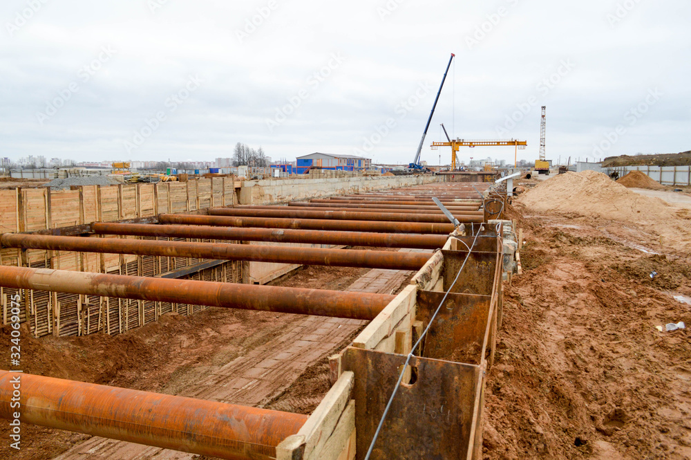 Poster a large huge ditch pit tunnel with reinforcing structures from thick iron pipes of beams and structu