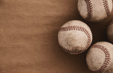 Vintage texture sports balls background with close up of used baseballs and copy space.