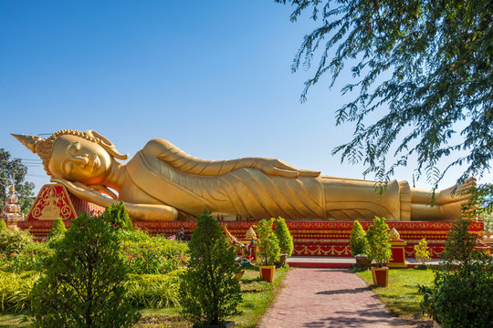 Golden Reclining Buddha in gardens at Wat Pha That Luang Vientiane Laos,Vientiane