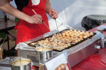 Cooking takoyaki on open air