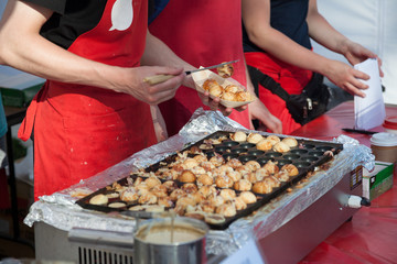 Cooking takoyaki on open air
