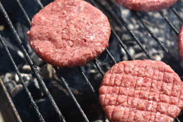 cooking burgers on the grill in nature