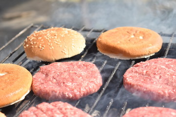 cooking burgers on the grill in nature