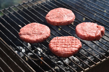 cooking burgers on the grill in nature
