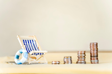 Miniature Beach Chair with Increasing Stacks of Coins