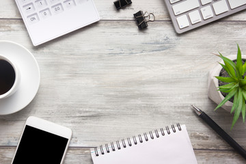 White desk office with laptop, smartphone and other work supplies with cup of coffee. Top view with copy space for input the text. Designer workspace on desk table essential elements on flat lay
