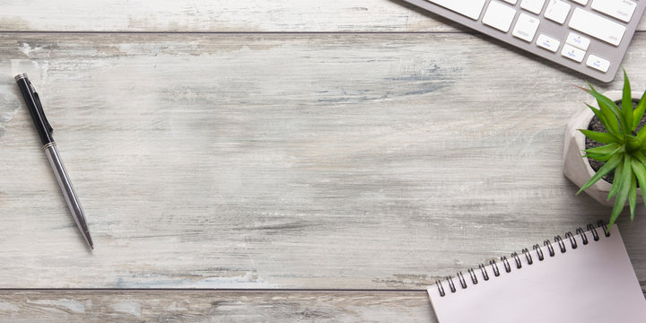 White desk office with laptop, smartphone and other work supplies with cup of coffee. Top view with copy space for input the text. Designer workspace on desk table essential elements on flat lay