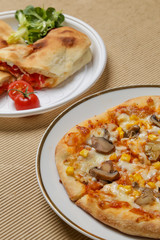 Small homemade vegetarian pizza with mushrooms and sweet corn