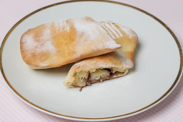 Sweet pineapple chocolate pastry roll with sugar icing