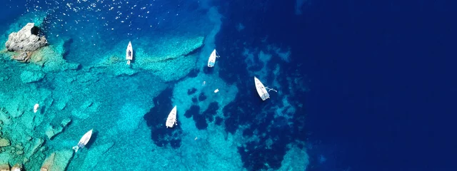 Poster Aerial drone ultra wide photo of sail boat docked in tropical exotic bay with turquoise clear sea © aerial-drone
