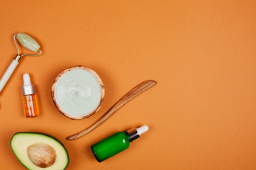 Modern accessories and herbal cosmetics for natural face care. Flat lay style.