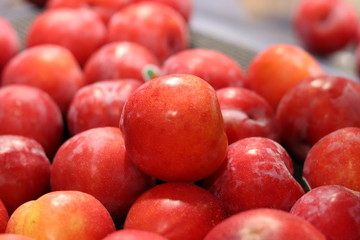 Bright red sweet apples on display in a grocery store/ supermarket