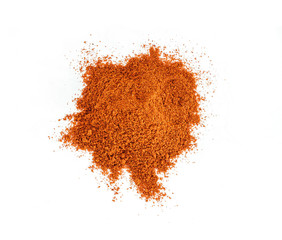 Powdered pimienta roja red pepper pile from top on white background.