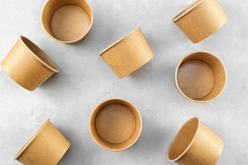 Top view of eco kraft paper cups on grey background