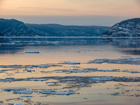 Lake Between Mountains with Chunks of Ice in the Water, Early cold Winter in Matane, Quebec / Canada