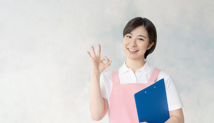 Obraz premium OKする保育士 介護士
