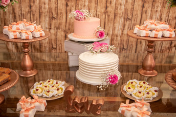 Wedding Setup. Cake table with sweet, decoration and flowers 