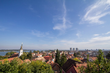 Aerial view of Zemun district, seen from the panoramic location of Gardos, in Belgrade, Serbia, during a sunny afternoon, with the river Danube and churches in the background