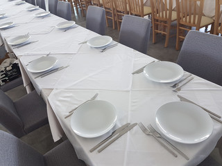 long table plates forks and spoons empty for background