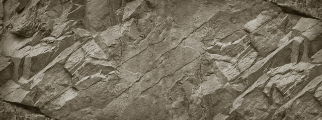 Stone wall. Rock texture. Brown gray grunge backdrop. Rocky texture background with copy space for design. Web banner. Wide. Panoramic.