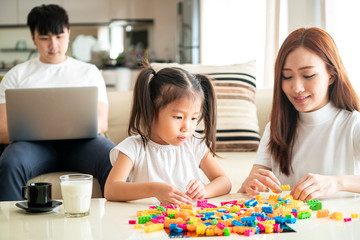 Obraz na płótnie Canvas Asian beautiful Mother and her Daughter playing toy together in living room at their home in a relaxing day, Asian family Concept