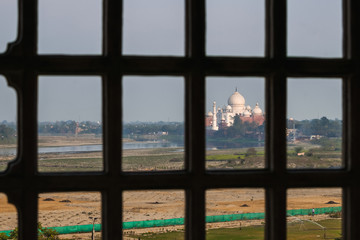 Taj Mahal view from Agra fort behind bars, India