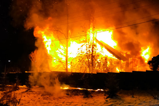 house is burning, a house fire in a village, firefighters exting