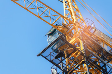 Building crane  under construction against blue sky