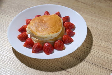 pancake and strawberry fruit sweet dessert food put on breakfast table