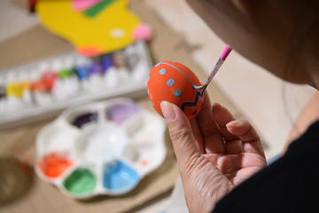 people painting easter egg custom pattern design with watercolor