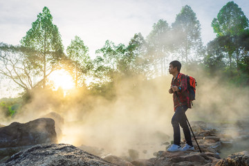 Traveler and Morning steam over hot spring at Chae Son National Park, Thailand.