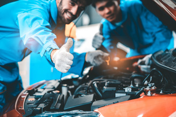 Car Mechanic Ready For Work. Auto Mechanic with Large Wrench in Hands. Ideas How to Fix the Problem.Male mechanics at the garage fixing a car.Closed up focus .
