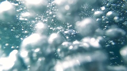 POV slow motion video of diver diving in ocean clear water and releasing air bubbles - Powered by Adobe
