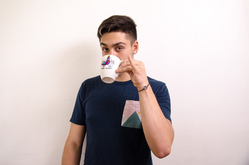 Young man drinking from a jug