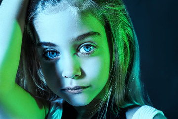 Toned portrait of cute girl on dark background