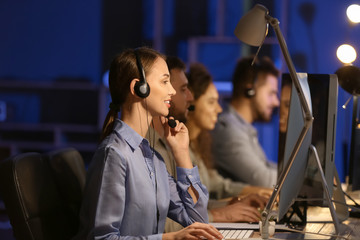 Technical support agents working in office at night