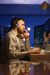 Technical support agents working in office at night