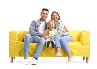 Happy young family sitting on sofa against white background