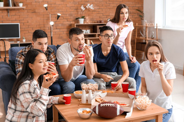 Group of fans watching rugby on TV