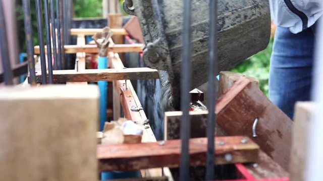 Mason or plasterer pour construction cement onfloor. pouring cement mortar into formwork.