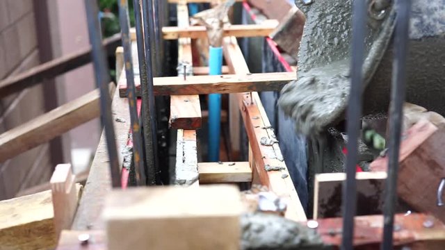 Mason or plasterer pour construction cement onfloor. pouring cement mortar into formwork.