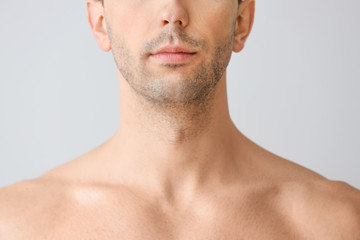 Naklejka premium Handsome young man on light background. Plastic surgery concept