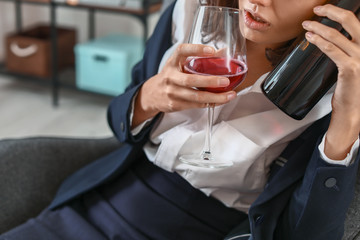 Woman drinking wine at home. Concept of alcoholism