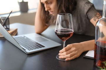 Young drunk woman in office. Concept of alcoholism